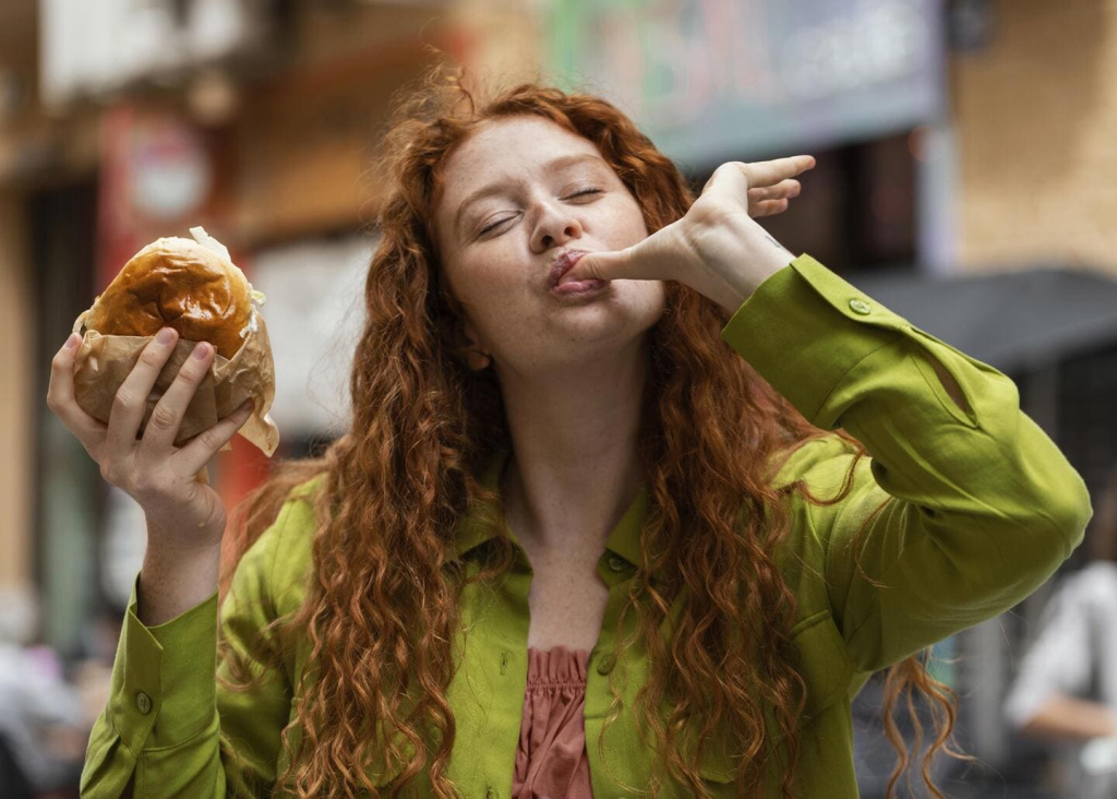 beautiful-woman-eating-delicious-street-food-outdoors.jpg